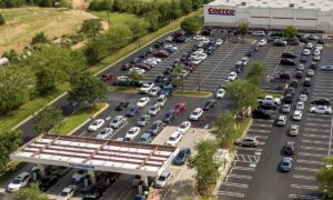 In this aerial image taken with a drone, numerous vehicles line up for gasoline at Costco on Wendover Avenue in Greensboro, N.C., on Tuesday, May 11, 2021. As the shutdown of a major fuel pipeline entered into its fifth day, efforts are under way to stave off potential fuel shortages, though no widespread disruptions were evident. The Colonial Pipeline, which delivers about 45% of the fuel consumed on the East Coast, was hit by a cyberattack on Friday. (Woody Marshall/News & Record via AP)